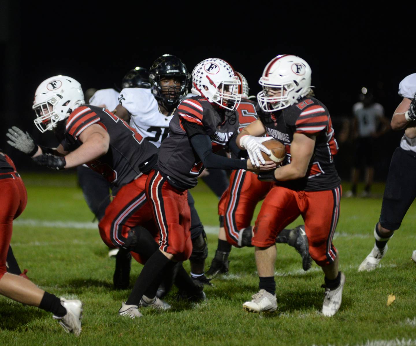 Forreston quarterback Brady Gill hands the ball off to Kaleb Sanders during Friday, Oct. 20, 2023 action against Lena-Winslow at Forreston High School.