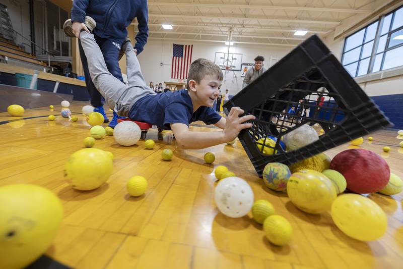 Wyatt Baker, 3rd grade, is pushed around by Eddie Sullivan, 4th grade, during an interactive “Hungry, Hungry Hippo” game at St. Mary’s School Thursday, Feb. 1, 2024 in Dixon. The students were treated to some fun in celebration of Catholic Schools Week.