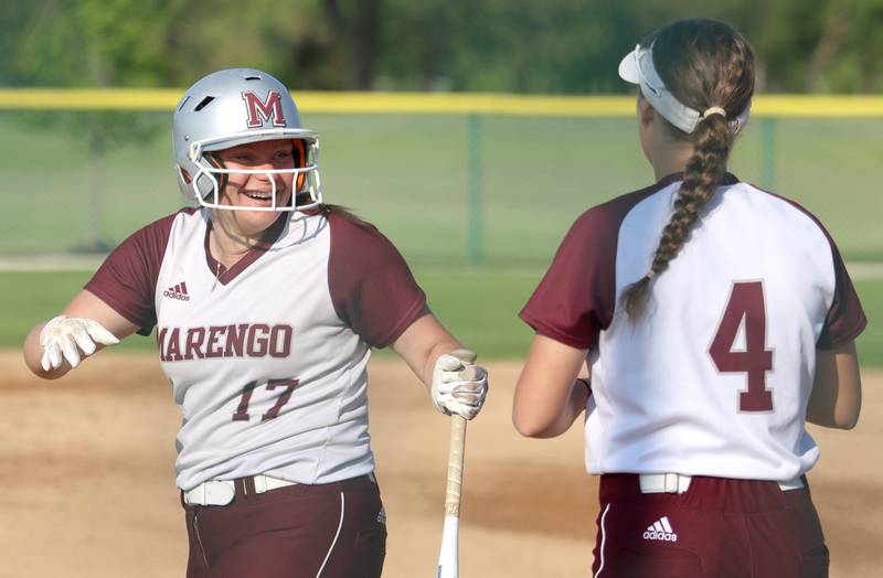 Marengo’s Mia Feidt, left, shares a laugh with Jozsa Christiansen during a win over Richmond-Burton in varsity softball at Marengo Monday.