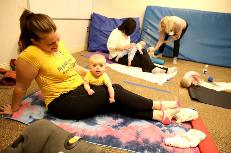 Kristen Calvallo of Hanover Park and her daughter, Kalylah, 5 months, participate in a baby yoga class at Northwestern Medicine Central DuPage Hospital in Winfield.