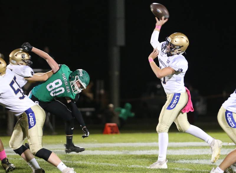 Marquette quarterback Anthony Couch looks to throw as Seneca's Sam Finch is shoved away on Friday, Oct. 18, 2024 at Seneca High School.