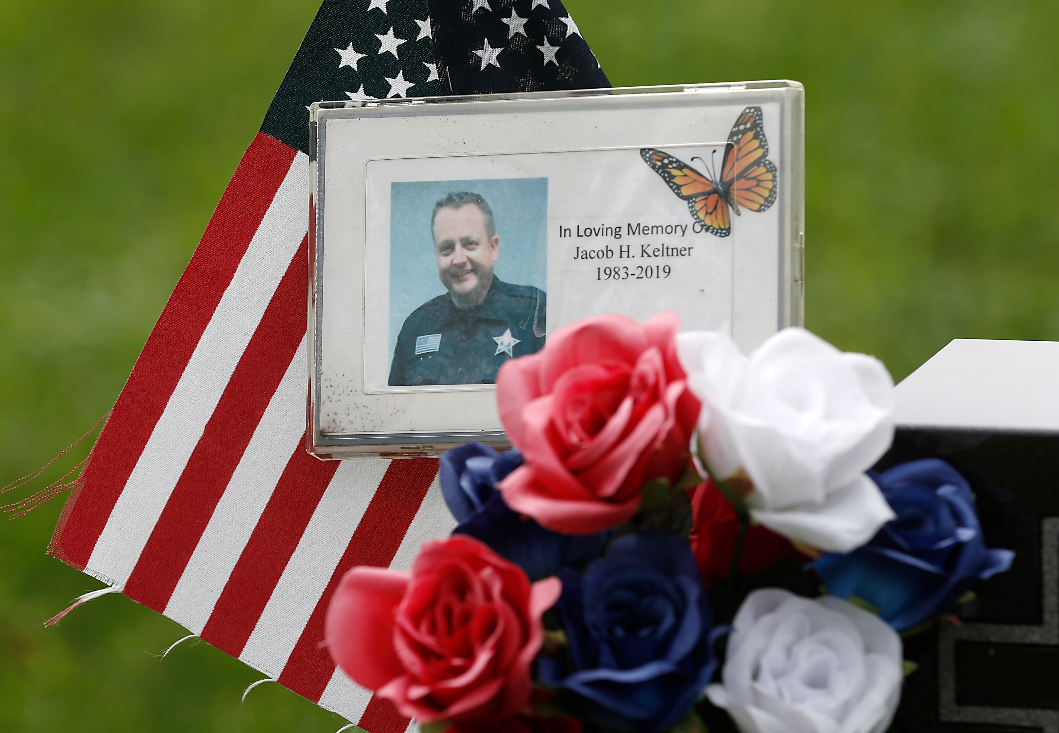 A detail of items left at the headstone for McHenry County sheriff’s Deputy Jacob Keltner, on Monday, Aug. 29, 2022, in Crystal Lake Memorial Park, 8012 Ridgefield Road in Crystal Lake. Keltner was killed in the line of duty while serving an arrest warrant in Rockford in March 2019.