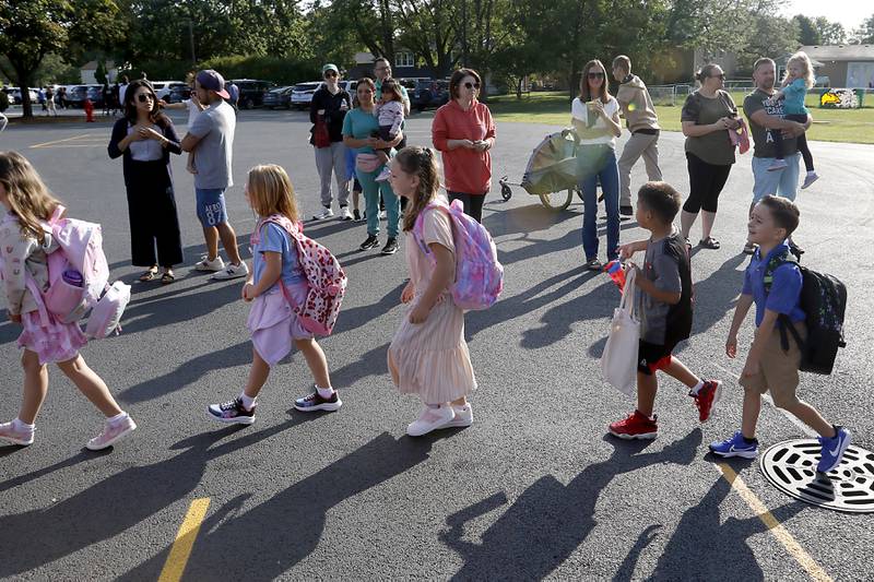 Parents watch as their children walks into the school for the first day of school on Wednesday, Aug. 21, 2024, at Coventry Elementary School in Crystal Lake.