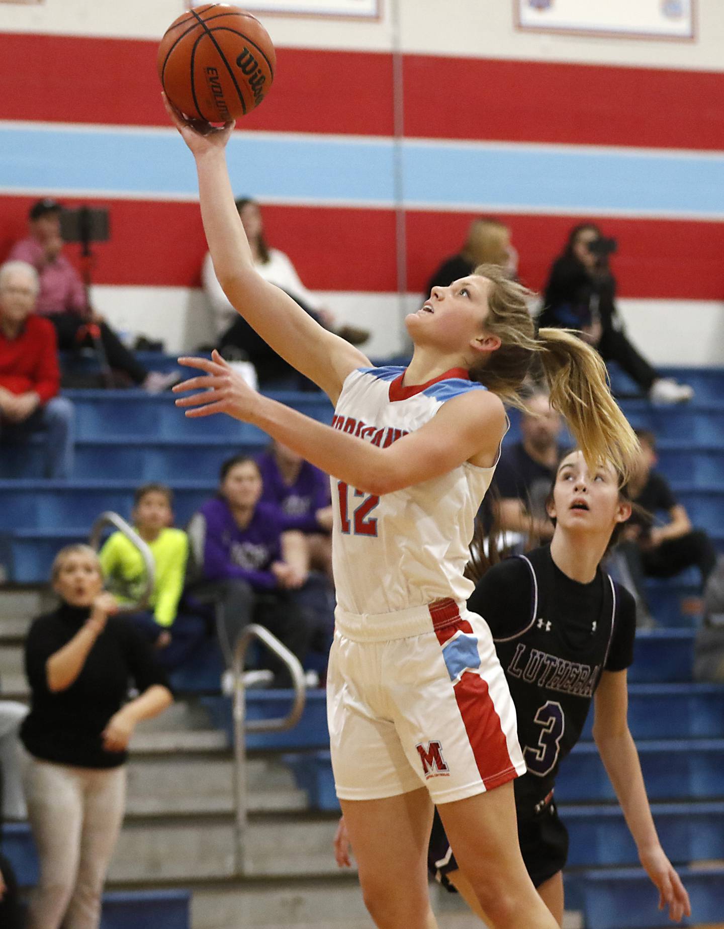 Marian Central's Madison Kenyon drives to the basket in front of Rockford Lutheran's Kaylee Bankes during a non-conference girls basketball game Monday, Dec. 12, 2022, between Marian Central and Rockford Lutheran at Marian Central Catholic High School, in Woodstock.