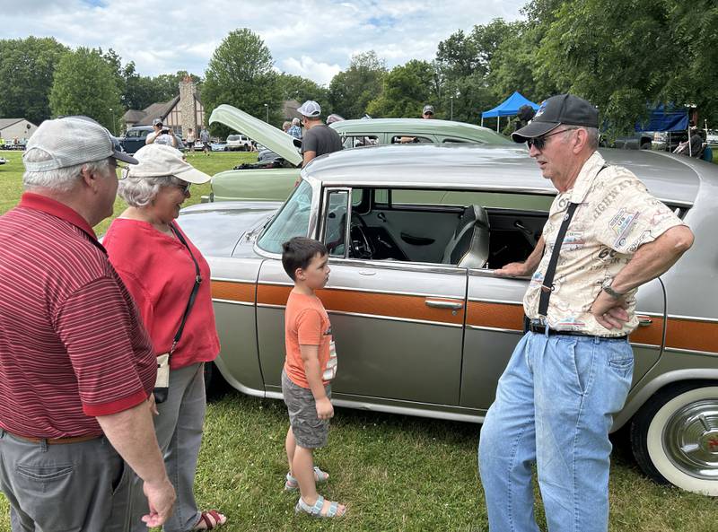 James Beymer of Henryella, Oklahoma visits with Jeff and Molly Hallock of Oregon and their grandson, Miles, 5, at the Nashional Car Show at the Stronghold Camp & Retreat Center north of Oregon on Saturday, June 29, 2024. Beymer brought his 1957 Rambler Rebel to the show.