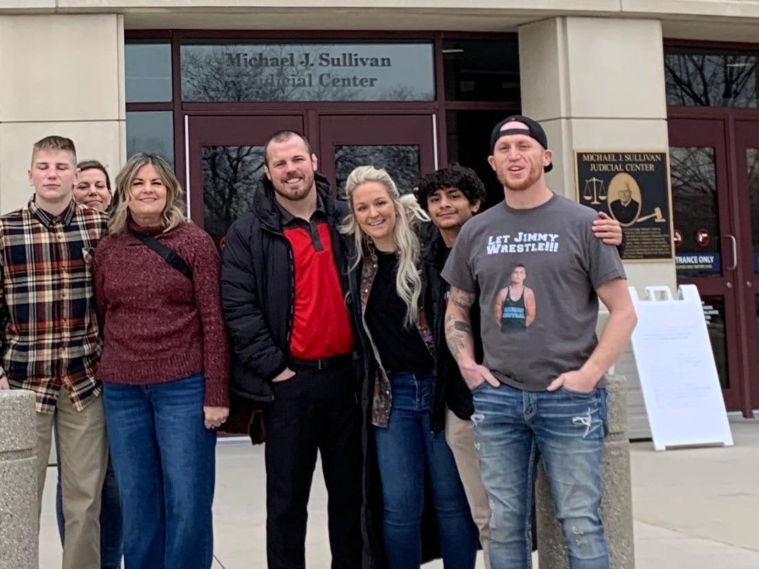 Marian Central Catholic High School student Jimmy Mastny and wrestling co-coach Jordan Blanton and supporters in front of the McHenry County courthouse on Dec. 21, 2023. Mastny and Blanton are seeking an injunction to stop IHSA suspensions.