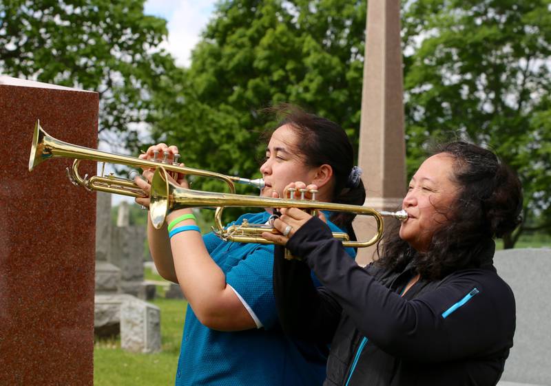 Clara Paulson and Maria Dripps Paulson play Taps at the Elburn American Legion Annual Memorial Day Observance at the Blackberry Township Cemetery on Monday, May 27, 2024.