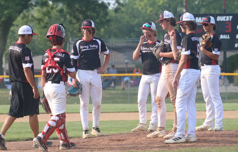 Members of the Spring Valley District 20 baseball team meet on the mound during the Central Region Baseball Tournament on Monday, July 24, 2023 at Washington Park in Peru.