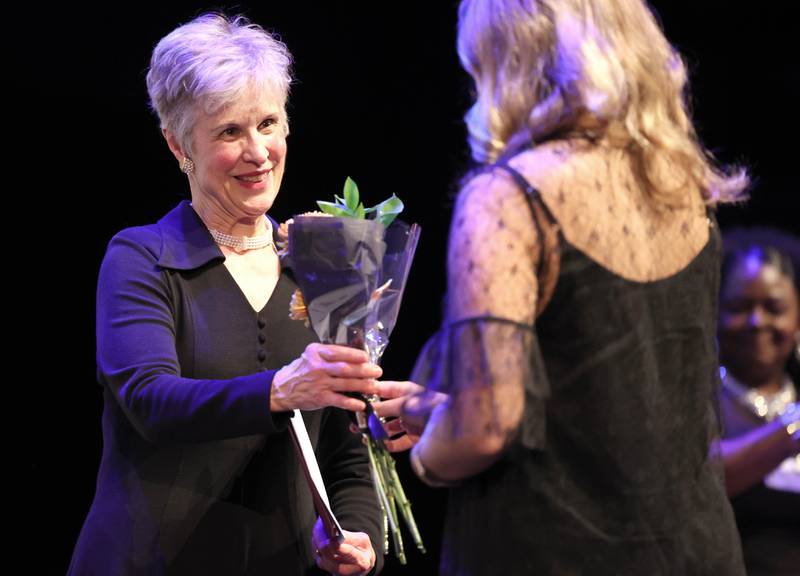 Women of Accomplishment Honoree Lynn Neeley receives her gift Thursday, Oct. 19, 2023, during the Athena and Women of Accomplishment Awards reception hosted by the DeKalb Chamber of Commerce at the Egyptian Theatre.