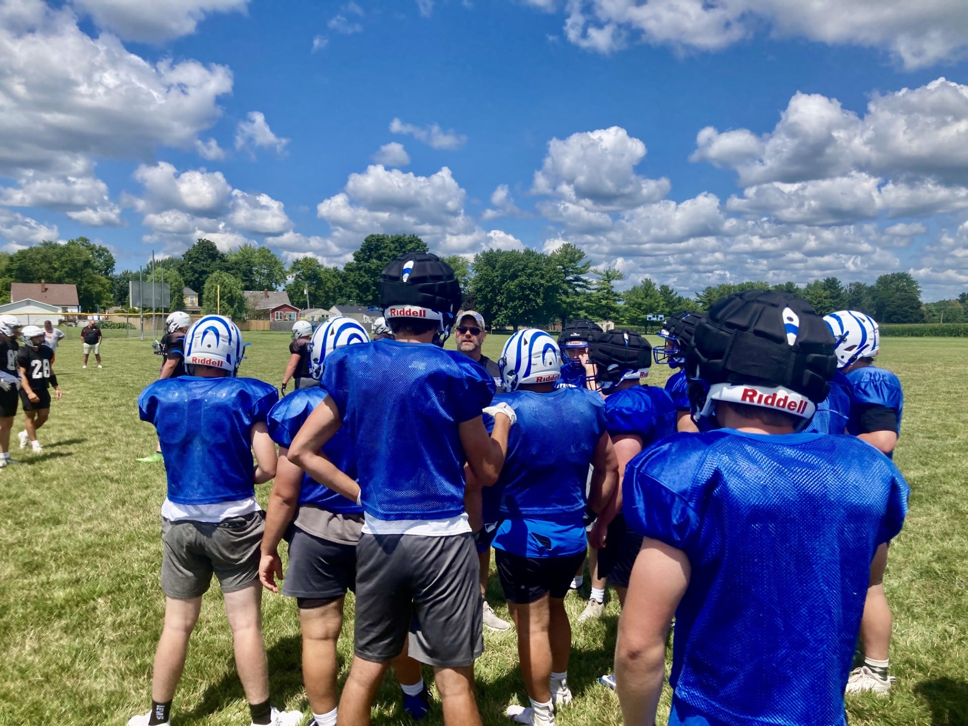 Princeton coach Ryan Pearson huddles up the Tigers for the controlled practice/scrimmage at Little Siberia Field on Thursday, July 18.