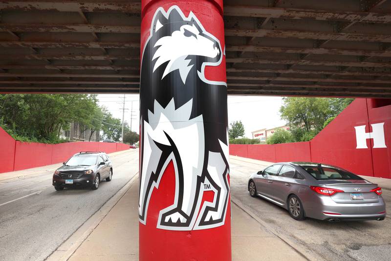 Vehicles drive by part of the new Huskie mural Monday, Aug. 7, 2023, on the Annie Glidden Road railroad underpass, just south of Lincoln Highway in DeKalb. The mural was a joint project between the City of Dekalb and Northern Illinois University.