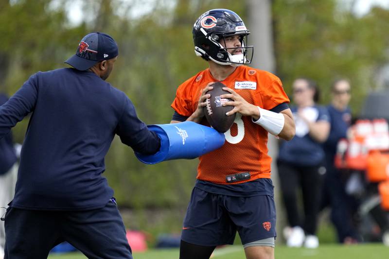 Chicago Bears quarterback Caleb Williams, right, works with a coach during the NFL football team's rookie camp earlier this month at Halas Hall in Lake Forest, Ill.