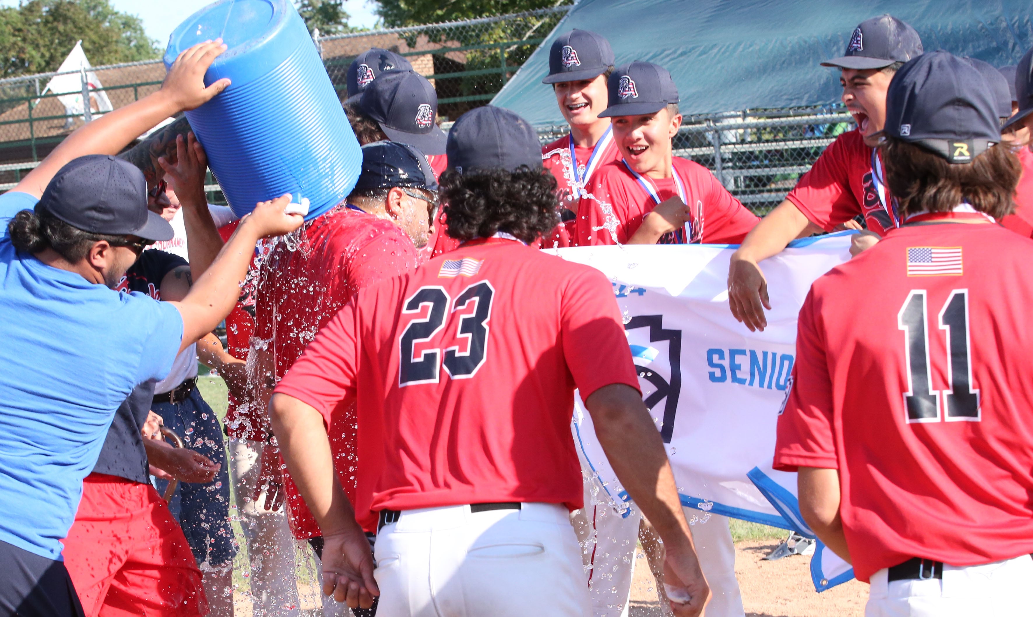 Water is dumped on the Burbank Senor League Baseball team after defeating Michigan during the Central Regional  Baseball Tournament Championship game on Thursday, July 18, 2024 at J.A. Happ Field in Washington Park in Peru.