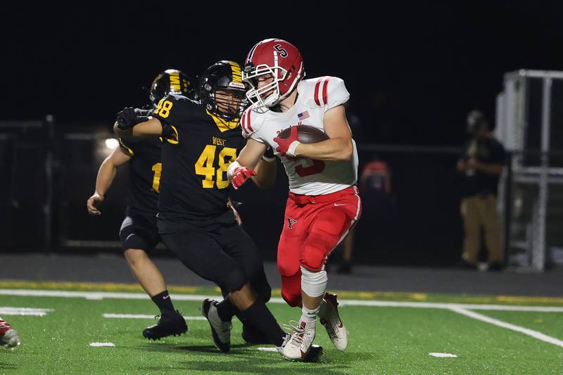 Yorkville’s Ryan Wulff rushes against Joliet West on Friday, Sept. 13, 2024 in Joliet.