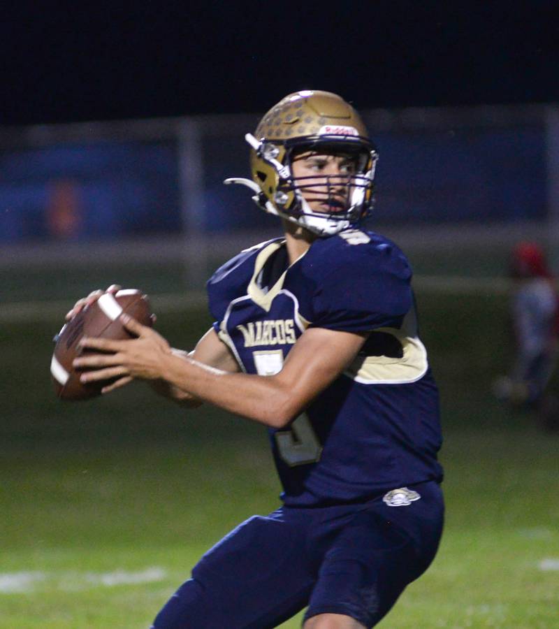 Polo's Gus Mumford has his eyes on a receiver as he drops back to pass during 8-man football action against Hiawatha on Friday, Sept. 13, 2024 in Polo.