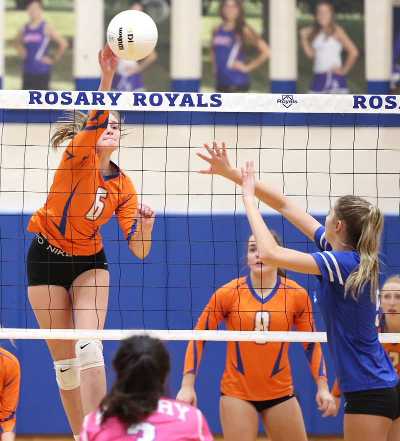 Genoa-Kingston's Kaitlin Rahn tips the ball past Rosary's Clare McEniry during their Regional semifinal match Tuesday, Oct. 25, 2022, at Rosary High School in Aurora