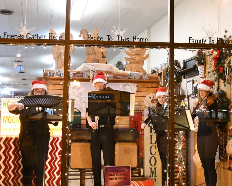 Sycamore High School orchestra members perform Christmas carols during the Sycamore Chamber of Commerce's annual Moonlight Magic event held in downtown Sycamore on Friday, Nov. 17, 2023.