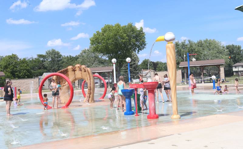 Children play with water in the Splash Field at Washington Park on Monday, June 17, 2024 in Peru.