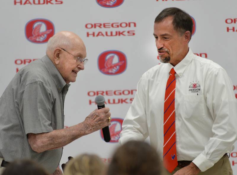 Oregon Activities Director Mike Lawton (right) presents the Friends of Athletics OCUSD Hall of Fame award to Bob Groenhagen during a ceremony on Saturday, Sept. 14, 2024 at the Rock River Center in Oregon. Bob and his late wife, Leona, received the award for supporting OHS sporting events for 40 years.