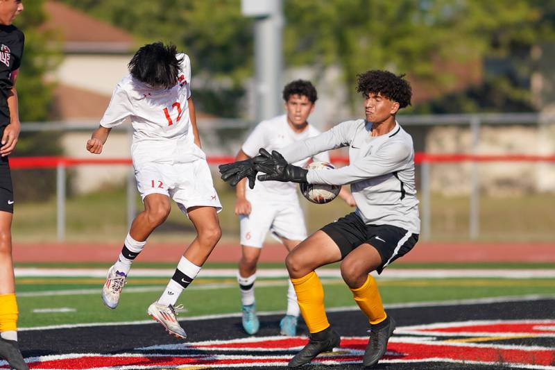 Yorkville's Caleb Reveter (right) blocks a shot attempt by Oswego’s enrique castaneda III (12) during a soccer match at Yorkville High School on Tuesday, Sep 17, 2024.