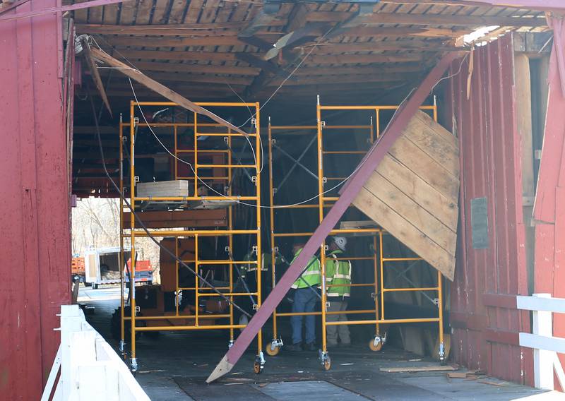 An Illinois Department of Transportation crew begins repairs on the Red Covered Bridge on Monday, Dec. 11, 2023 in Princeton. The bridge was severely damaged when it was struck by a semi truck on Nov. 16.