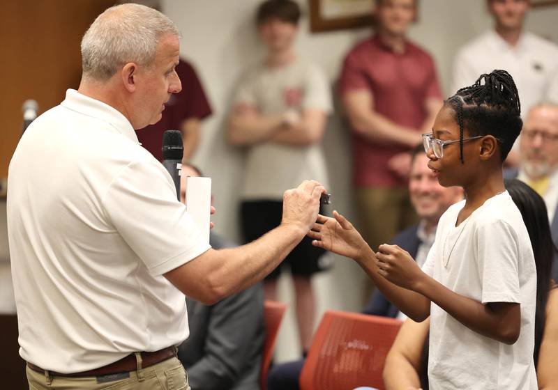 DeKalb Mayor Cohen Barnes presents Elijah Livingston with a key to the city Monday, July 10, 2023, during the DeKalb City Council meeting. Livingston also learned his wish was granted by Make-A-Wish Illinois.