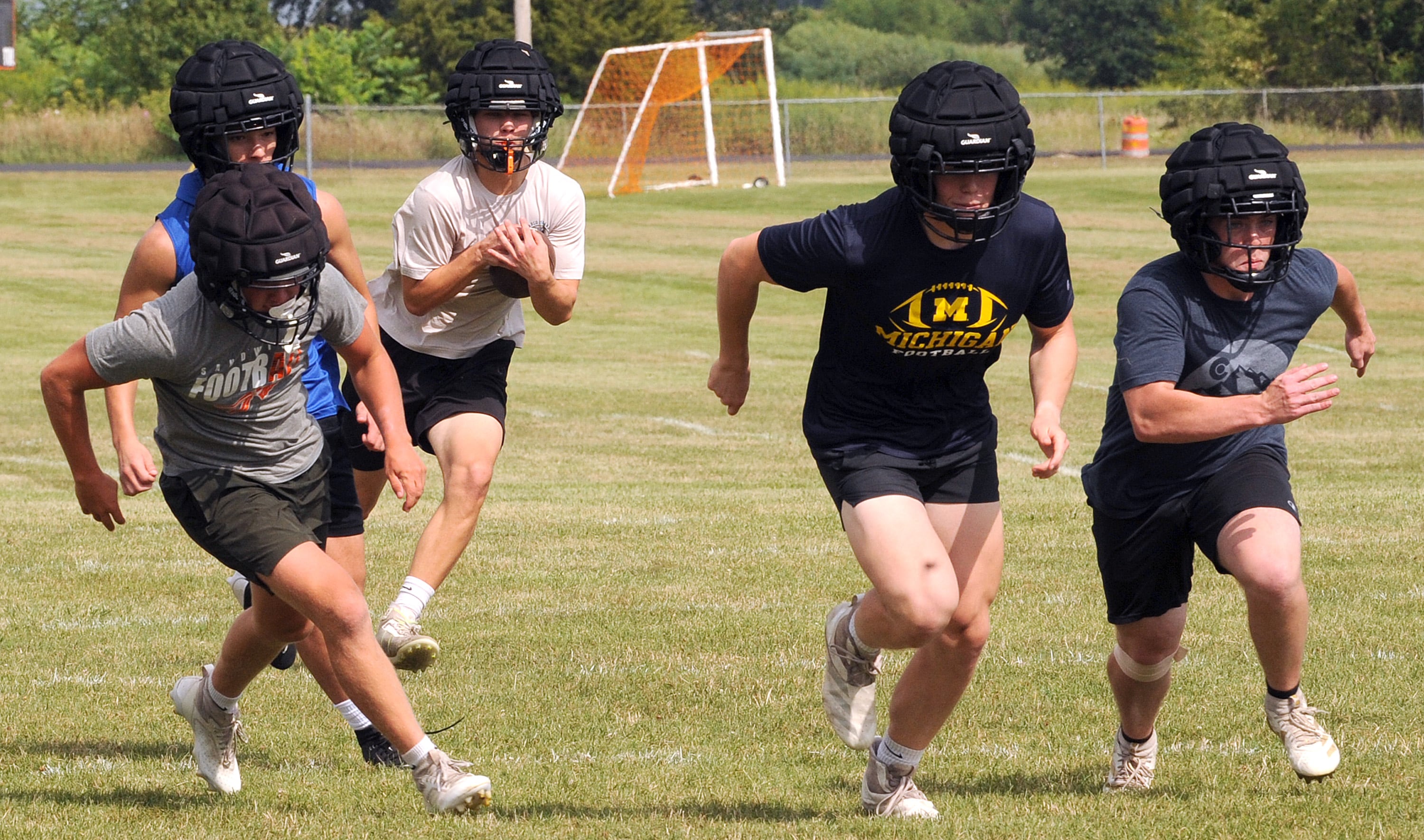 Nick Michalek follows his blockers during a kickoff return drill on the first day of football practice at Sandwich High School on Monday, Aug. 12, 2024.