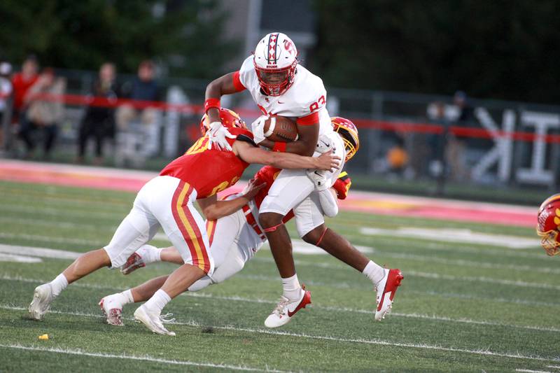 South Elgin’s Ishmael George is tackled by Batavia’s Chase Osborne and Jake Feller during a game Friday, Sept. 6, 2024 at Batavia.