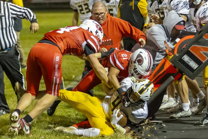 Demarcus Hunter of Streator Highschool tackles an opposing player out of bounds which ended up with a broken first down marker at Doug Dieken Field on October 18, 2024.