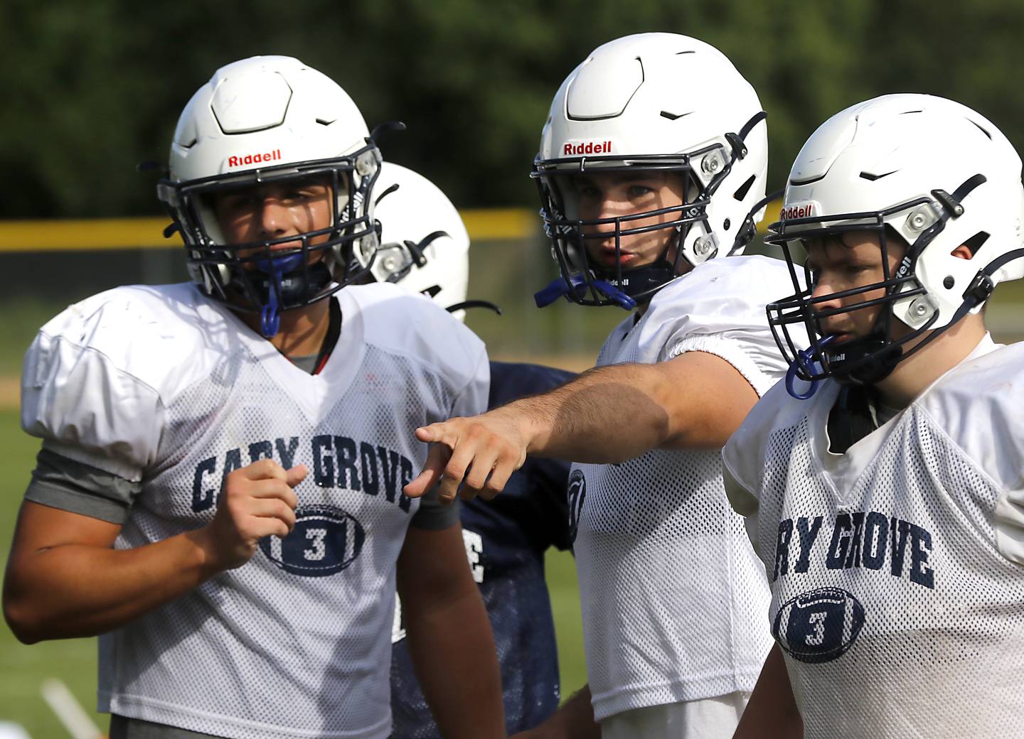 Logan Abrams (center) points where to be to teammates during drills during football practice Tuesday, Aug. 20, 2024, at Cary-Grove High School, as the 2023 IHSA Class 6A champions look to defend their title.