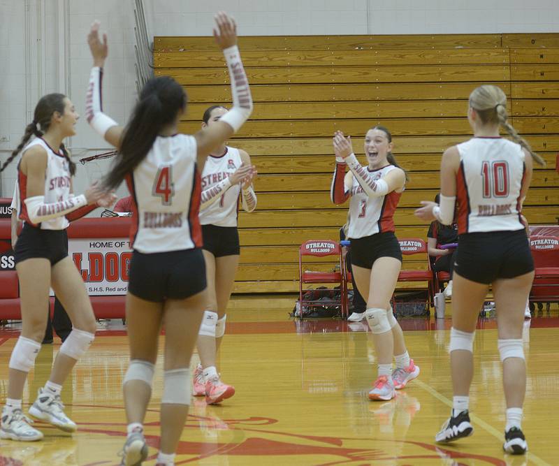 The Lady Bulldogs celebrate a point against East Peoria during the 1st set Monday at Streator.